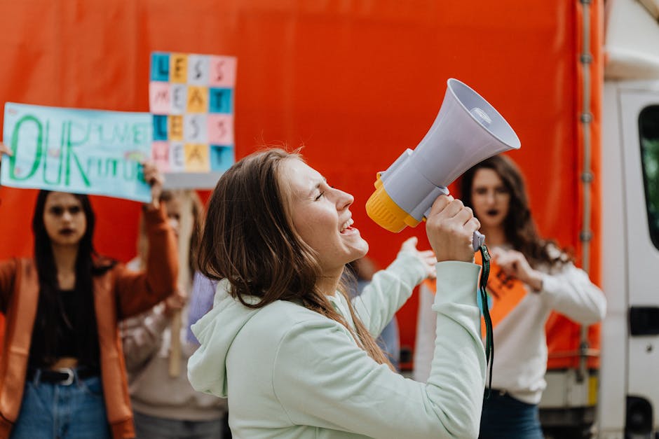 A diverse group of people participating in an environmental awareness rally with signs and banners